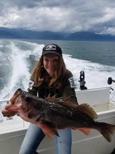 Female fishing with a Rock Fish on deck, Juneau Alaska fishing charter