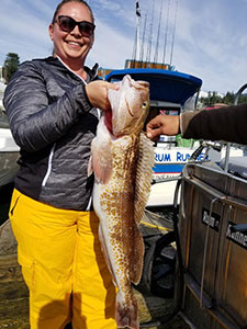 Female fishing with a Rock Fish on deck, Juneau Alaska fishing charter